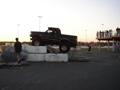 1995 Ford Bronco - A black 1995 Ford Bronco navigates an obstacle course made of concrete blocks.