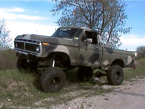 1977 Ford F-150 - This lifted 1977 Ford F-150 pickup truck is painted in a camouflage pattern and sits high off the ground.