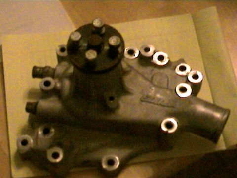 1977 Ford F-150 - A water pump part is shown in detail, with multiple bolt holes and connections visible.