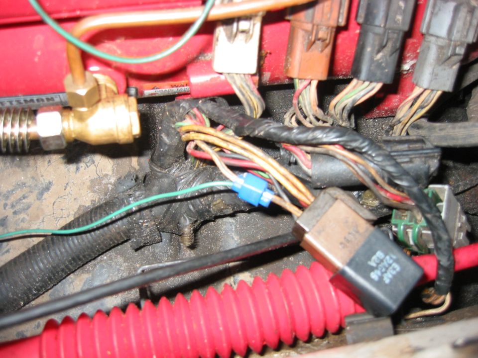 This is a blue/white wire to either  the EEC or Fuel Pump relay.
It is the most convenient tie-in I could find for the fan controller.