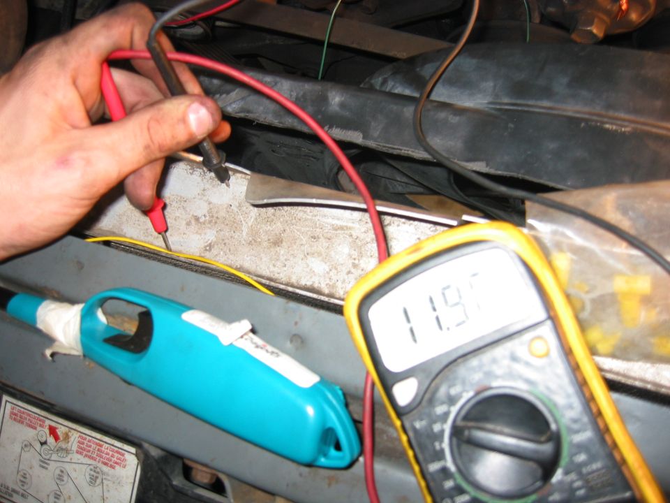 This is the yellow wire from the fan controller that ties into the IGN ON blue/white wire by the FP/EEC relay. 
The glare on the meter is hard to see, but the key is on and its showing 12V, so this part of the circuit is working.