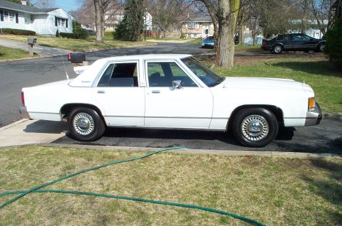 1991 Ford Crown Victoria LTD - This 1991 Ford Crown Victoria LTD is seen from the side in a suburban driveway.