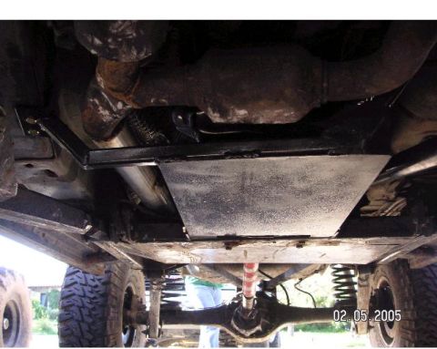 1999 Jeep Grand Cherokee - This photo shows the undercarriage of a vehicle, focusing on the exhaust system and suspension components.