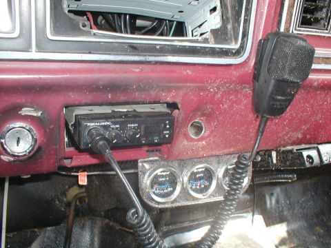 1979 Ford Bronco - The interior of a 1979 Ford Bronco shows a Realistic CB radio and aftermarket gauges installed on the dashboard.