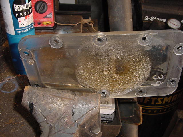Clear plastic part with visible "39" marking, held in a vise