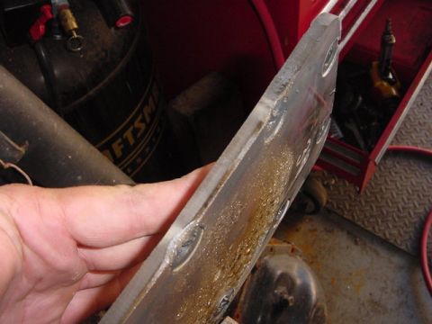 1971 Ford Bronco - A close-up shows a metal component with visible welds and oil residue, likely from an automotive repair or restoration project.