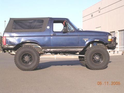 1994 Ford Bronco - This lifted Ford Bronco features a soft top and appears to be a 1994 model based on its body style.
