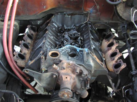 1979 Ford Bronco - Overhead view into an engine bay showing a V8 partially disassembled: the intake manifold, carburetor and valve covers are removed, exposin…