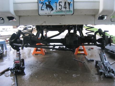 1997 Jeep Cherokee - Rear axle and suspension of a 1997 Jeep Cherokee undergoing work, supported by jack stands.