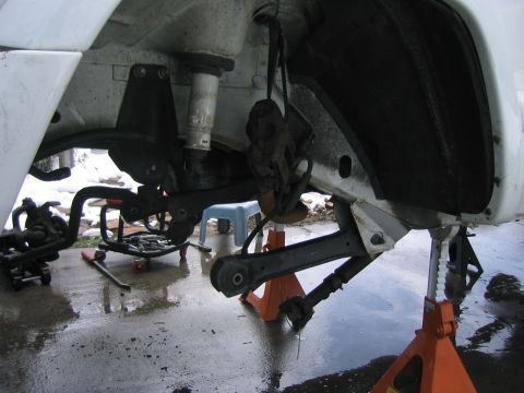1997 Jeep Cherokee - Front suspension work on a 1997 Jeep Cherokee, with parts removed and vehicle on jack stands.