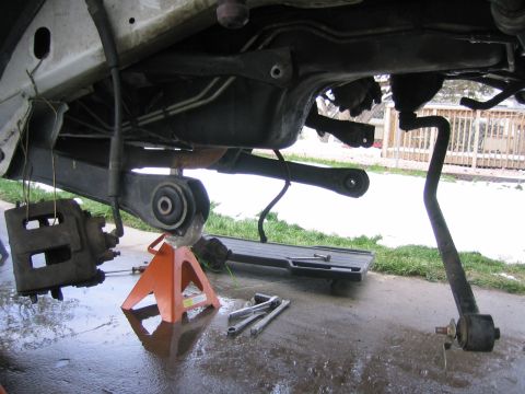 1997 Jeep Cherokee - Vehicle undercarriage with suspension components disassembled and supported by jack stands.