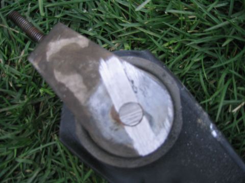 1997 Jeep Cherokee - An automotive part, possibly a mount or bracket, is shown against a background of green grass.