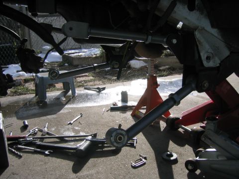 1997 Jeep Cherokee - Suspension components and tools are laid out on the ground, with the "SUPERMOTORS.NET" logo visible in the lower right corner.