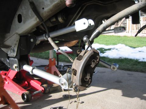 1997 Jeep Cherokee - Front suspension of a 1997 Jeep Cherokee XJ undergoing modifications with upgraded components.