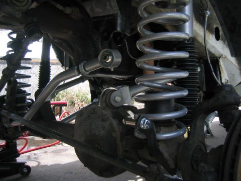 1997 Jeep Cherokee - Close-up view of the suspension system on a 1997 Jeep Cherokee, highlighting upgraded shocks and springs.