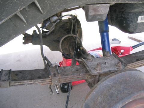 1997 Jeep Cherokee - Close-up of a vehicle's rear suspension system, including the axle and leaf springs.