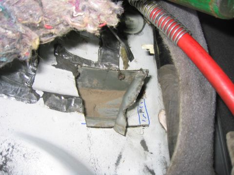 1997 Jeep Cherokee - This photo shows damage to the interior of a vehicle, including torn insulation and bent metal.