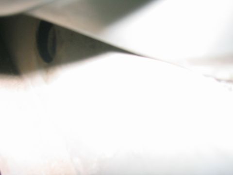 1997 Jeep Cherokee - A close-up view of a vehicle's undercarriage, with some unidentifiable components visible.