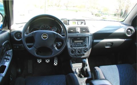 2002 Subaru Impreza - The interior of a 2002 Subaru Impreza shows a manual transmission and a MOMO steering wheel.