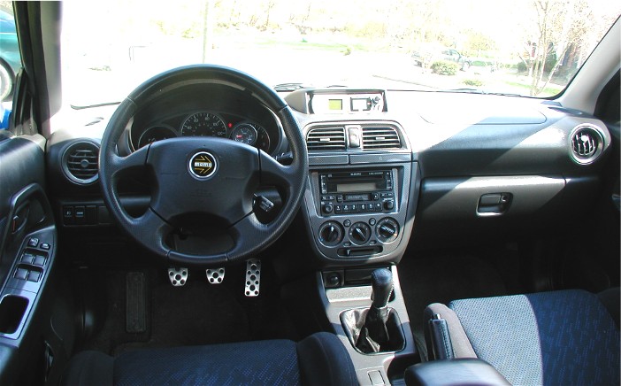 Fiat compact car interior with aluminum pedals and manual shifter