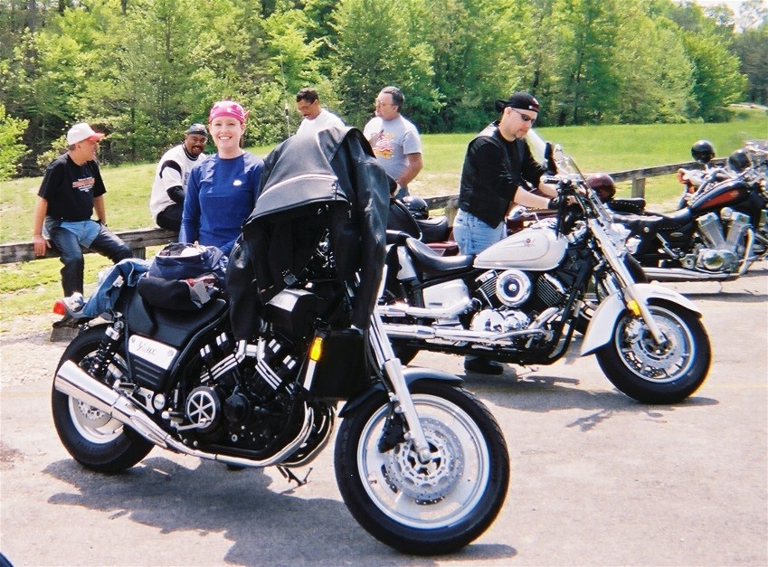 Black Yamaha V-Max with jacket over the seat at a roadside motorcycle gathering