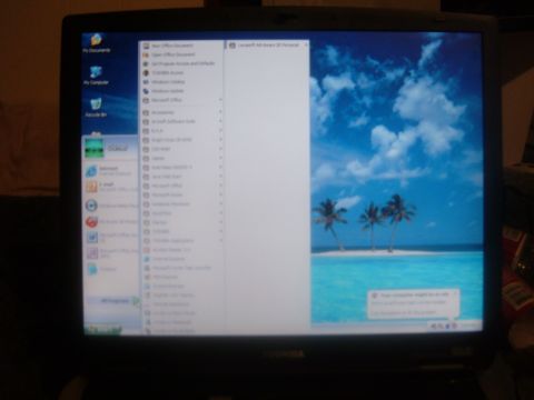 1985 Ford F-150 - A computer screen displays the Windows XP operating system with a tropical beach scene as the wallpaper.