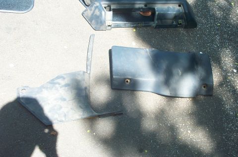 1991 Ford Crown Victoria LTD - Several plastic automotive trim pieces are shown on a paved surface.