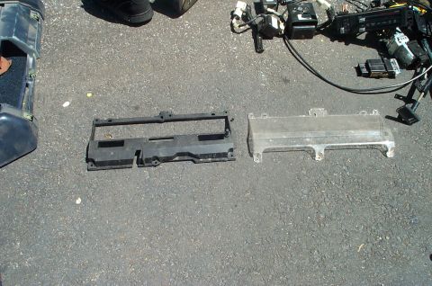 1991 Ford Crown Victoria LTD - Assorted automotive parts laid out on a paved surface, possibly for sale or repair.