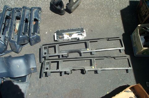 1991 Ford Crown Victoria LTD - Various dashboard trim pieces and an instrument cluster are displayed on the ground, likely for sale.
