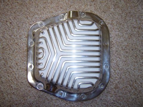 1978 Ford Bronco - This aftermarket differential cover has a finned design and is shown on a carpeted surface.