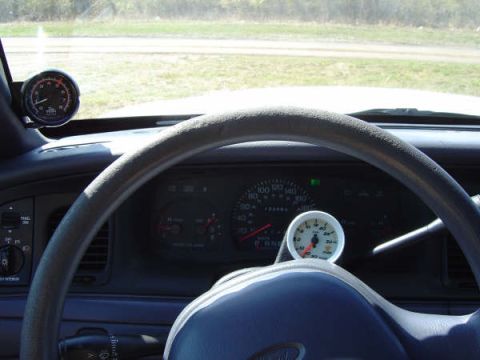 1998 Ford Crown Victoria - Interior view of a 1998 Ford Crown Victoria's dashboard, highlighting the speedometer and additional gauges.