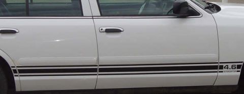 1998 Ford Crown Victoria - Side view of a white sedan black racing stripes and a "4.6 INTERCEPTOR" decal on the rear quarter panel.