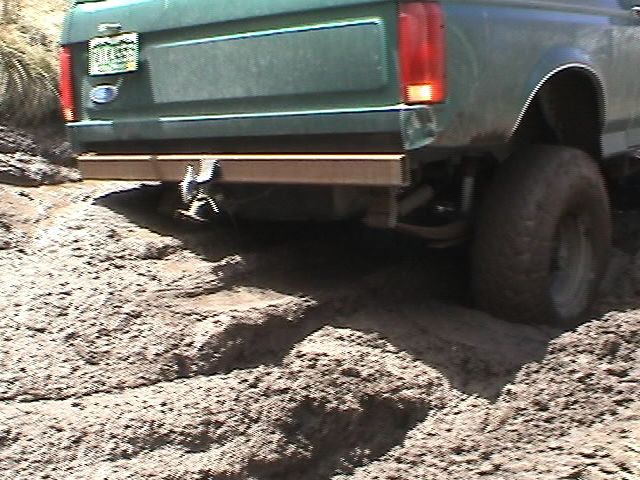 Green SUV rear view, off-roading in mud. 1979 Ford Bronco