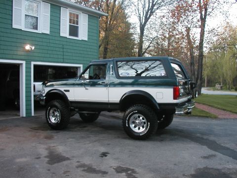 1994 Ford Bronco - Two-tone green and white 1994 Ford Bronco with aftermarket wheels and tires.