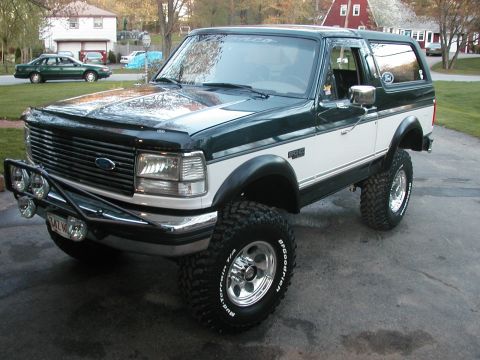 1994 Ford Bronco - This lifted Ford Bronco features a two-tone paint scheme and aggressive off-road tires.