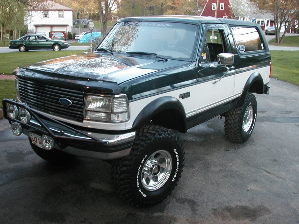 Green and white lifted Ford Bronco with BFGoodrich tires and brush guard