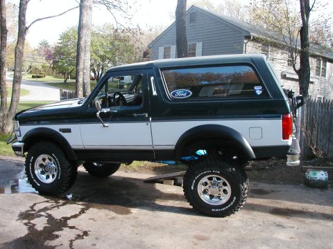 1994 Ford Bronco - Side profile of a lifted 1994 Ford Bronco with aftermarket wheels and tires.