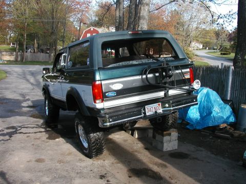 1994 Ford Bronco - Rear view of a lifted 1992 Ford Bronco on concrete blocks with a spare tire carrier.
