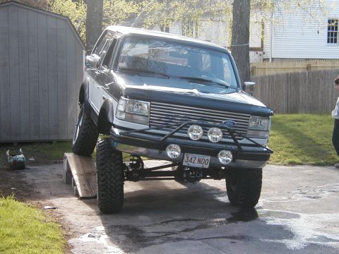 1994 Ford Bronco - This lifted Ford Bronco is positioned on a ramp, its off-road modifications.