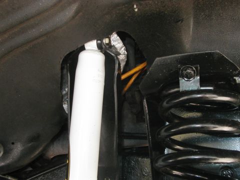 1994 Ford Bronco - Close-up view of the rear suspension components, including a shock absorber and coil spring.