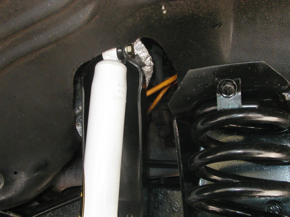 Rear suspension shock absorber and coil spring assembly