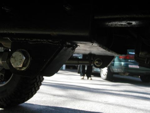 1994 Ford Bronco - Undercarriage view of a vehicle, with another car in the background.