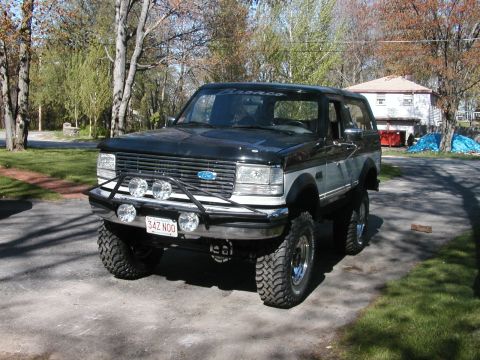 1994 Ford Bronco - This lifted 1994 Ford Bronco features a custom front bumper with auxiliary lights and a two-tone black and silver paint scheme.