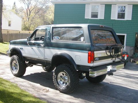 1994 Ford Bronco - This 1994 Ford Bronco is parked in a driveway with a house in the background.