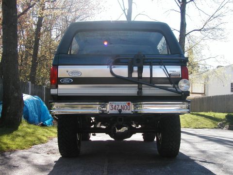 1994 Ford Bronco - The rear of a Ford Bronco shows its spare tire carrier and chrome bumper.