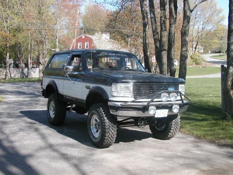 1994 Ford Bronco - This 1994 Ford Bronco features a two-tone paint scheme and an aftermarket brush guard with auxiliary lights.