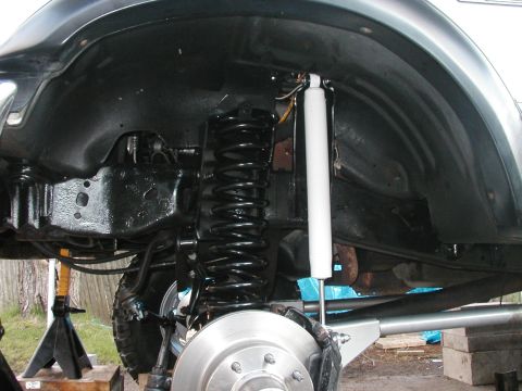 1994 Ford Bronco - The suspension system of a vehicle is shown with a focus on the shock absorber and coil spring assembly.