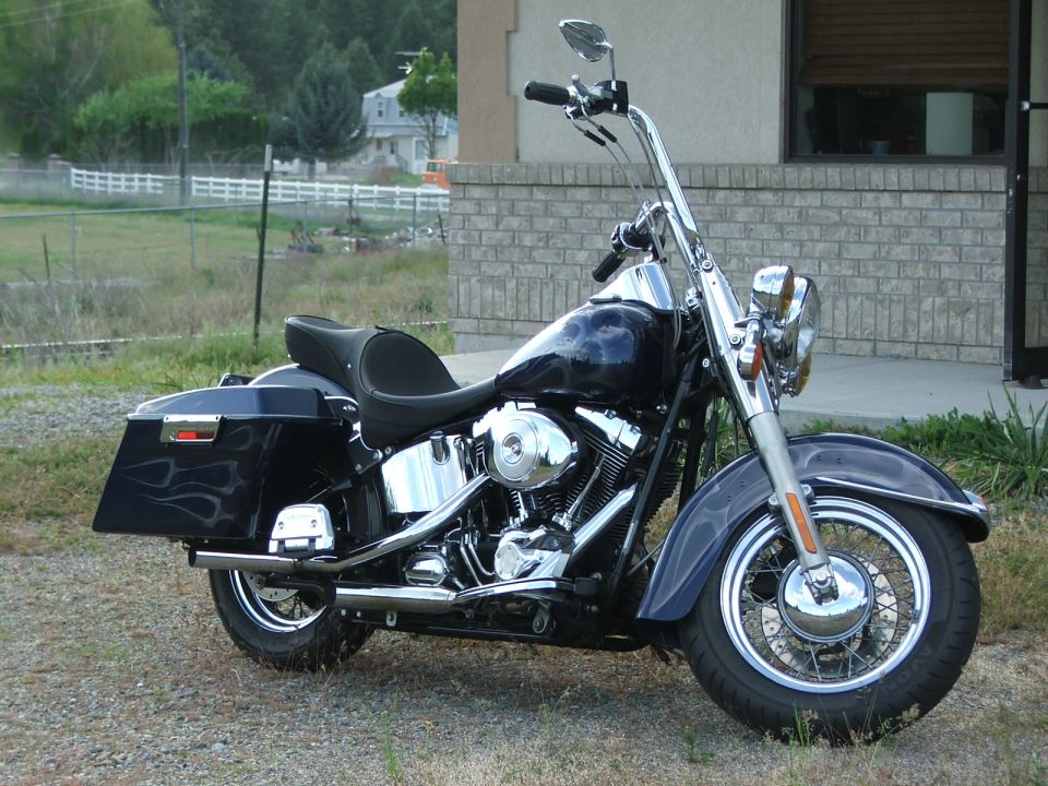 Dark blue motorcycle with flame decals, chrome accents, and saddlebags