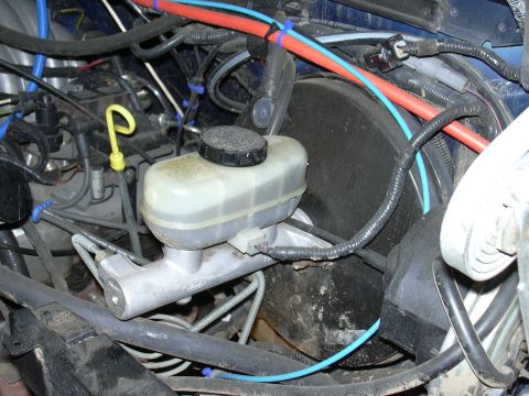 1991 Ford Bronco - Close-up of a vehicle's brake master cylinder with visible Ford branding.
