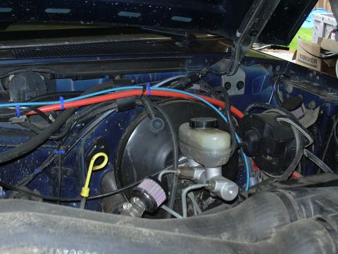 1991 Ford Bronco - Close-up view of the engine bay, focusing on the brake system components and wiring.